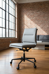 Grey leather office chair with black wheels and no armrests