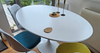 oval white wood dining table with tulip style dining chairs